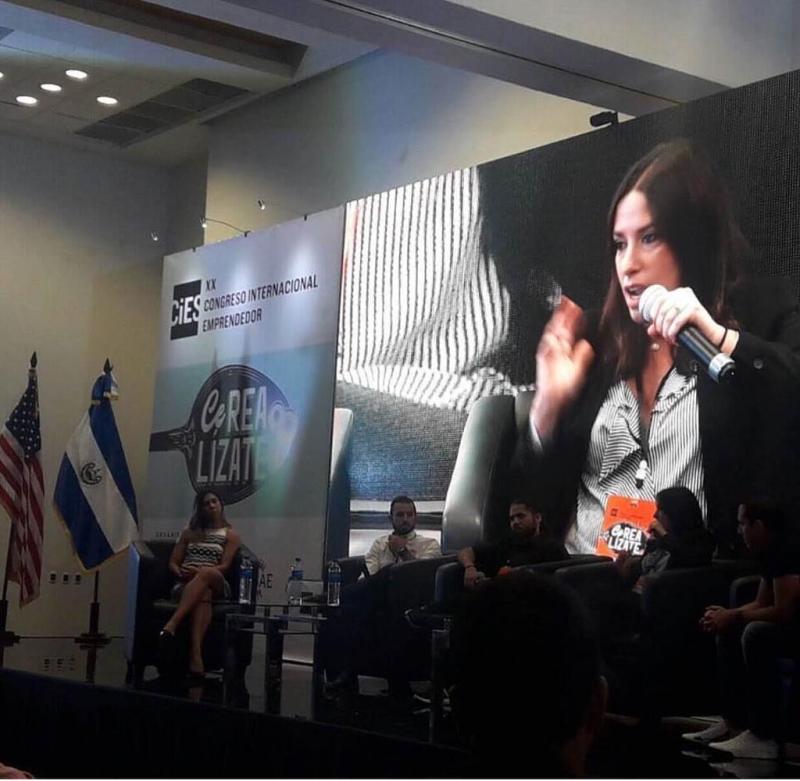 Florence Boza speaking on stage at an international entrepreneurship congress